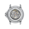 Close-up of a mechanical watch movement inside a silver case.