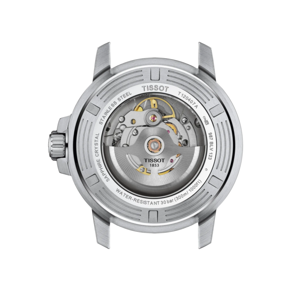 Close-up of a mechanical watch movement inside a silver case.