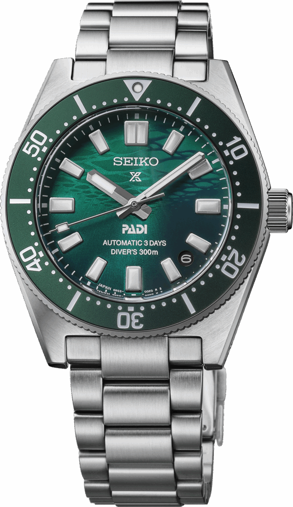 Close-up of a green Seiko dive watch with stainless steel bracelet.