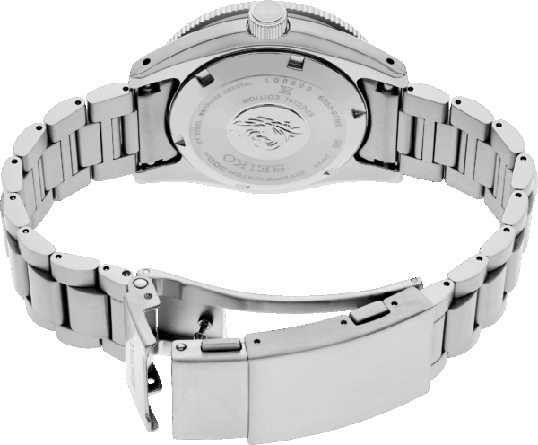 Close-up of a silver wristwatch with an open clasp showing the back case.