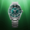 A sleek silver and green wristwatch with a metal bracelet on a green gradient background.