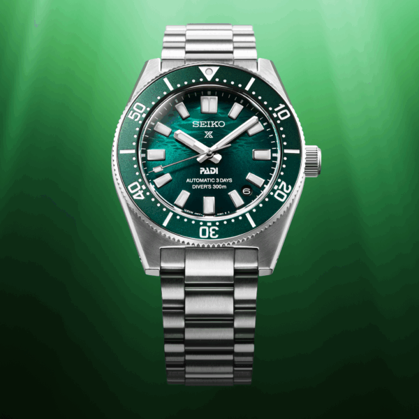 A sleek silver and green wristwatch with a metal bracelet on a green gradient background.