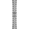 Close-up of a metal watch bracelet with a clasp on a black background.